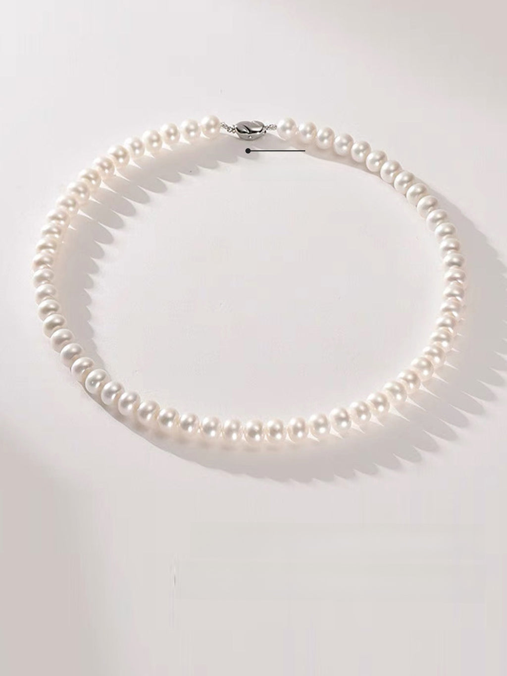 Pearl necklace on a white background
