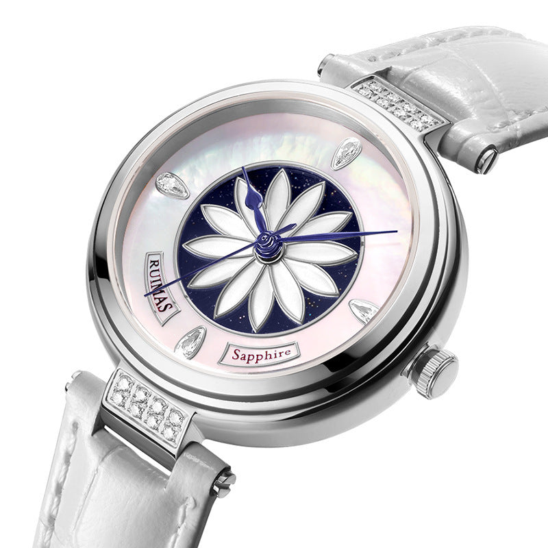 Watch with white strap and floral design on face against white background