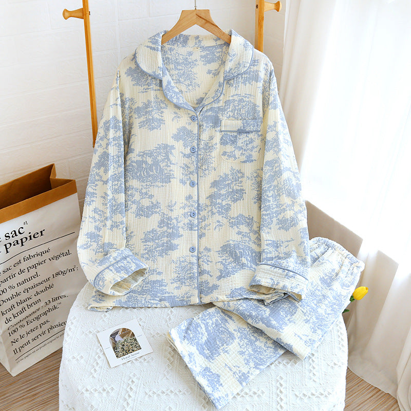 Floral patterned shirt and pants set on a white surface with a wooden box in the background.