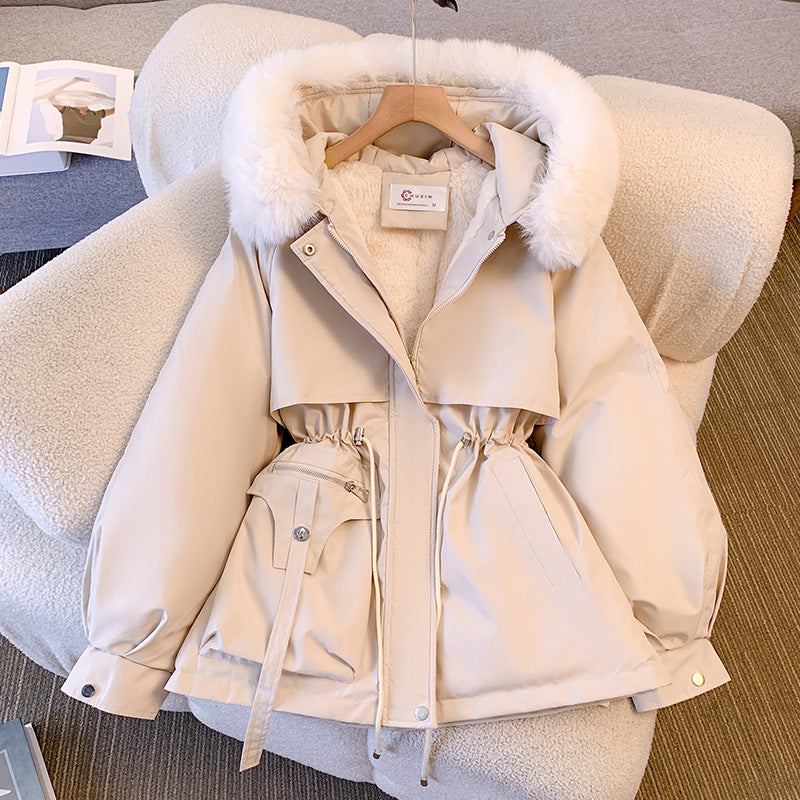 Beige winter jacket with fur hood on a chair