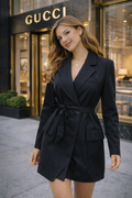 Woman in a black outfit standing in front of a Gucci store