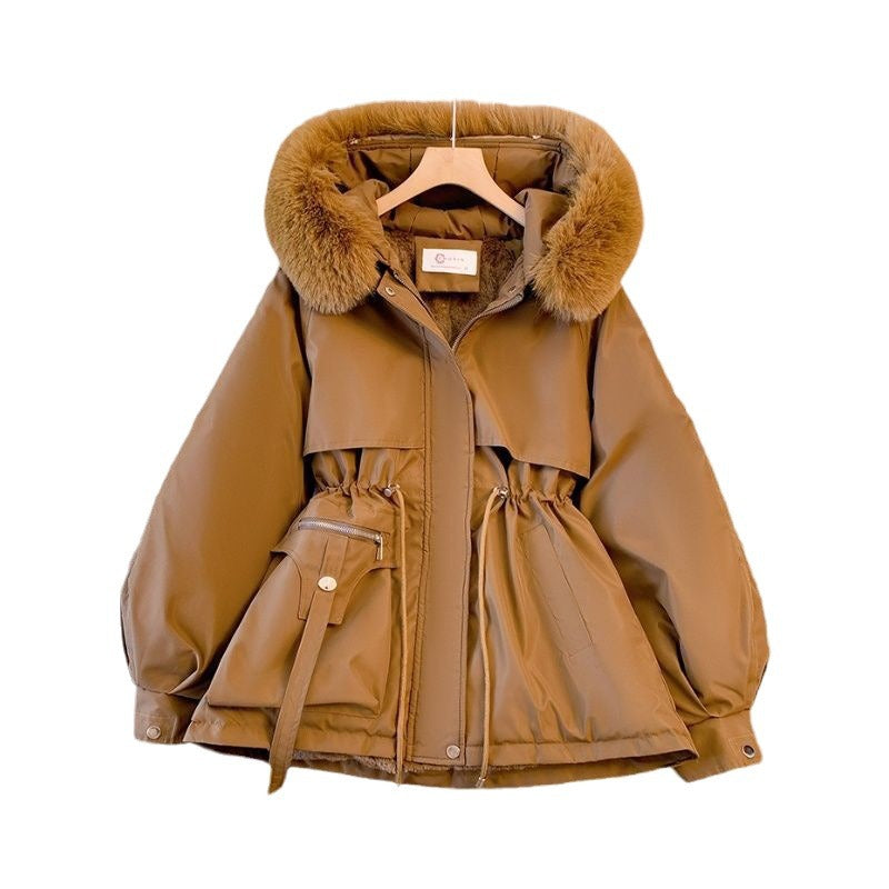 Brown jacket with fur hood on a hanger against a white background