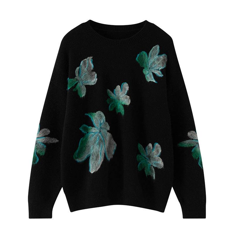 Black sweater with green floral patterns on a white background
